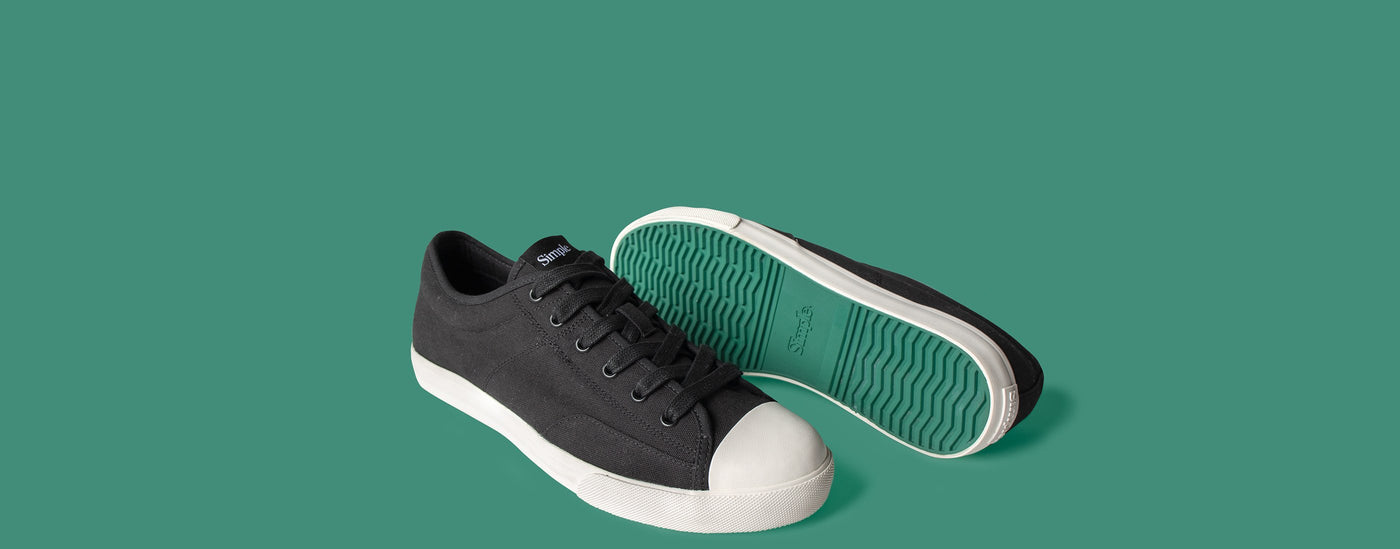 Black and White S1 Low Top Sneaker on a green background